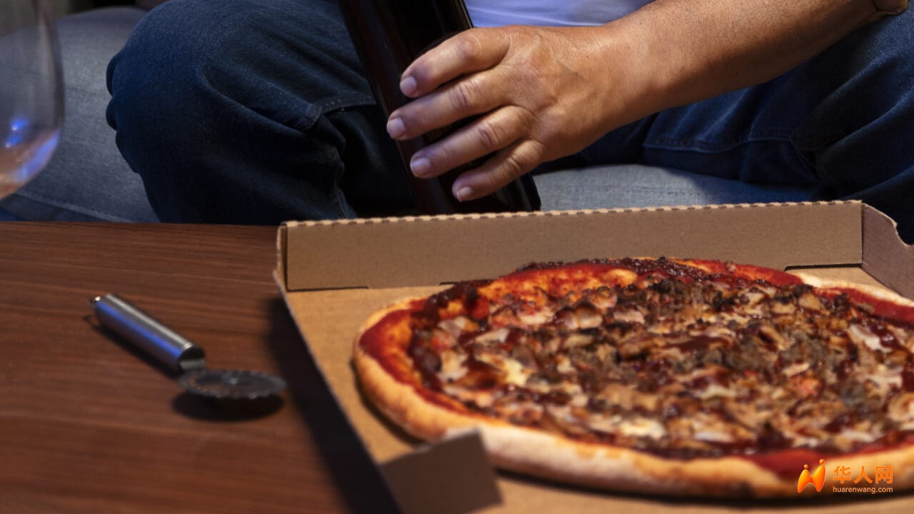 man-enjoying-pizza-wine-while-being-home-alone.jpg